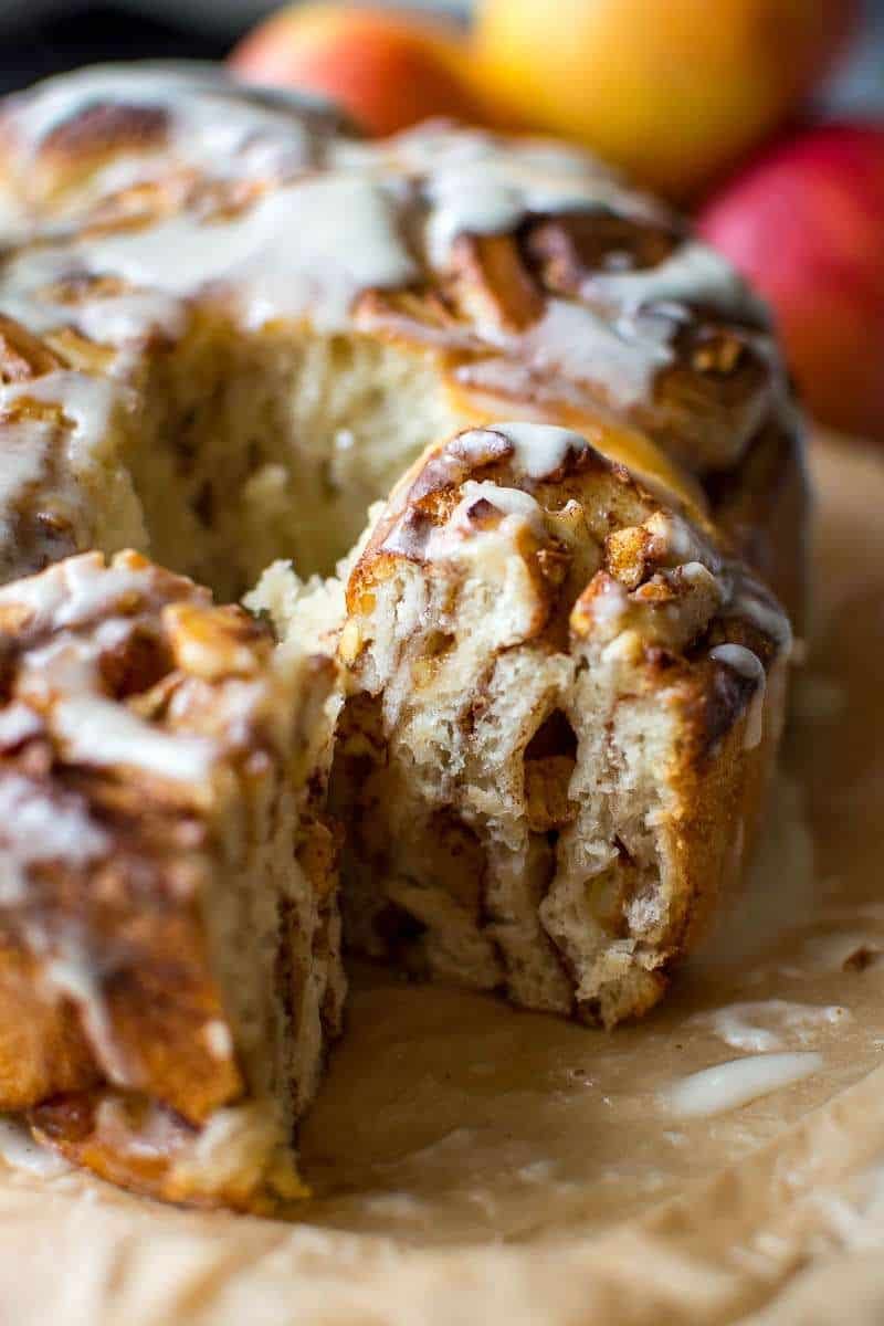 Tearing one sourdough apple cinnamon roll from the batch.