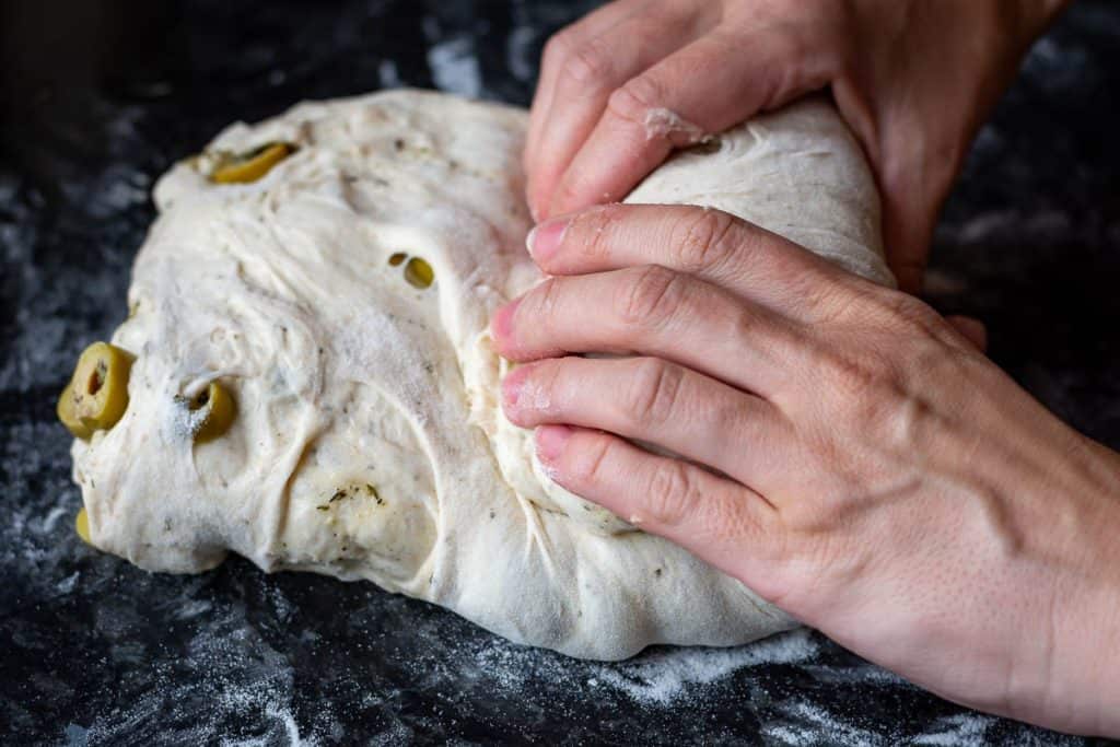 Shaping green olive sourdough.