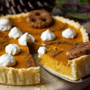 Pumpkin pie without evaporated milk being sliced into portions.