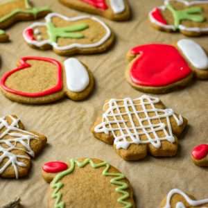Sourdough gingerbread cookies decorated with icing sugar on a baking parchment sheet.