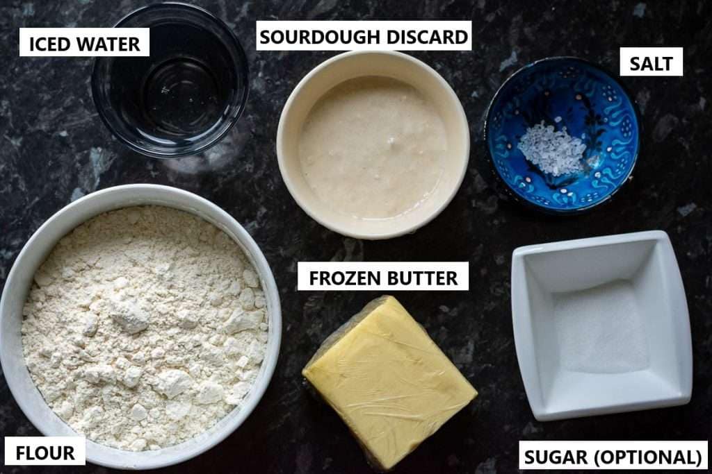 Ingredients for Sourdough Discard Pie Pastry on a dark surface.