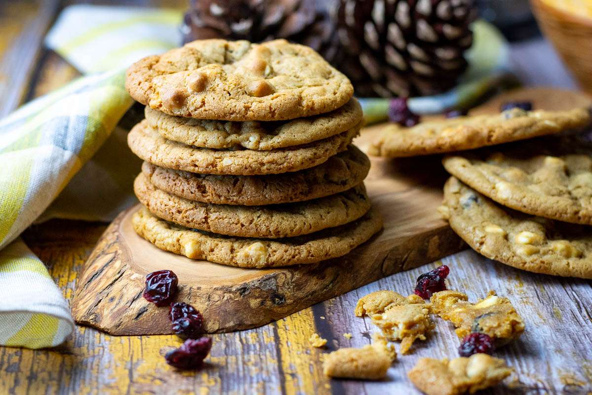 White Chocolate chip cookies on a wooden board.