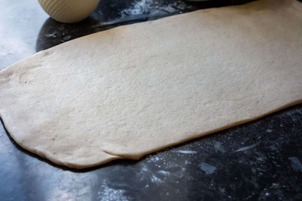 Sourdough rolled out into a large rectangle.