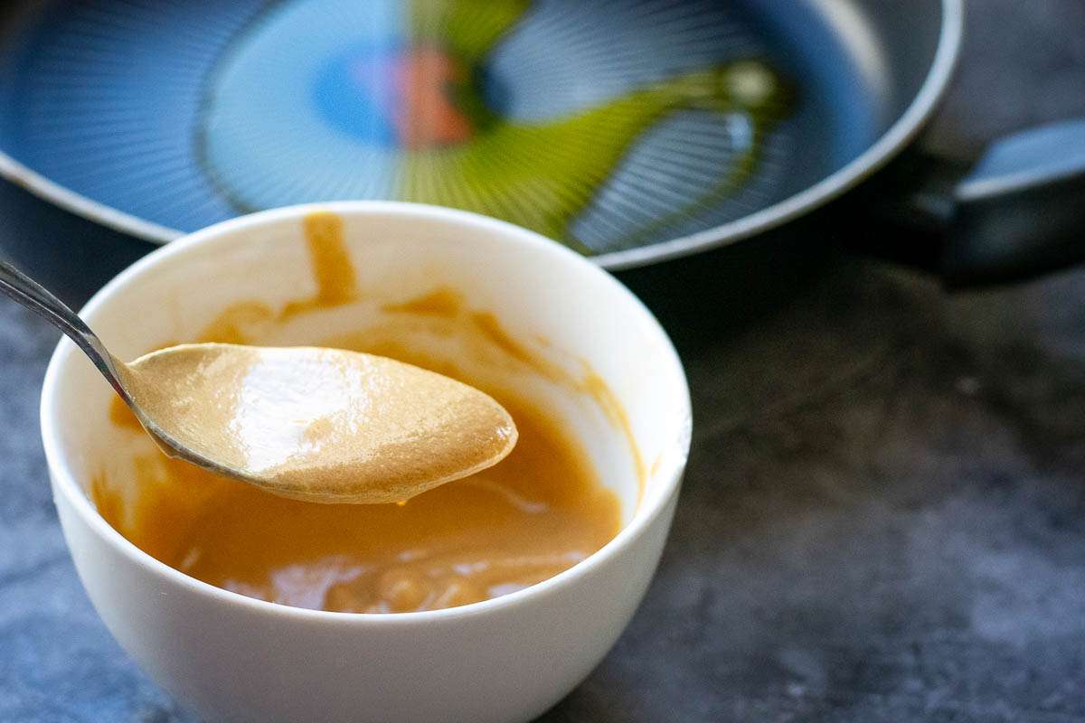 Tahini Dressing for the kale and sweet potato salad in a small white bowl.