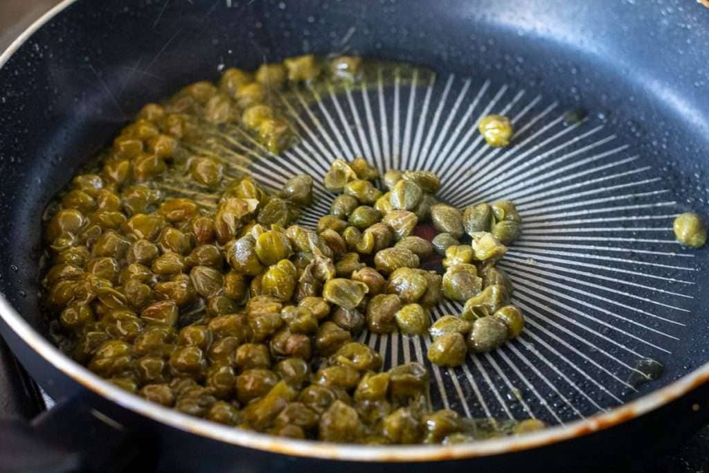 Capers frying in olive oil.