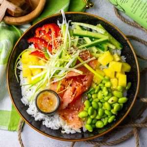Smoked Salmon Poke bowl with peppers, mango, edamame beans and spring onions.