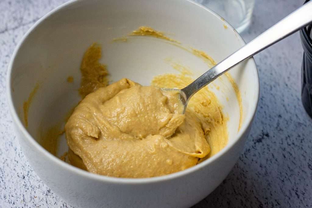 Mixing ingredients in a small white bowl.