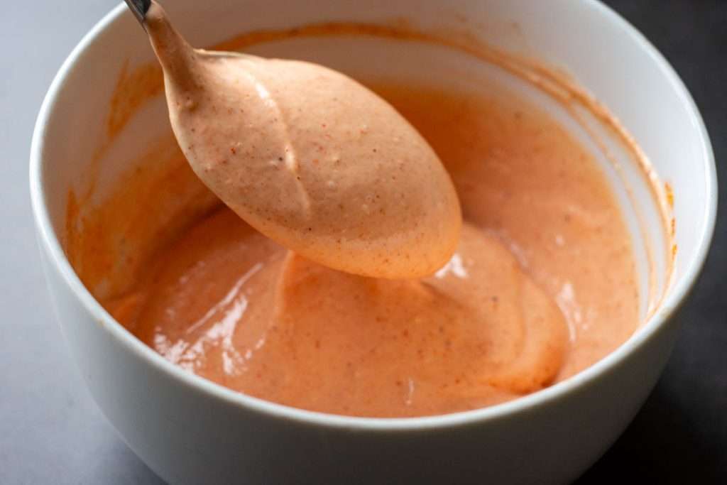 The sauce is mixed in a white bowl.