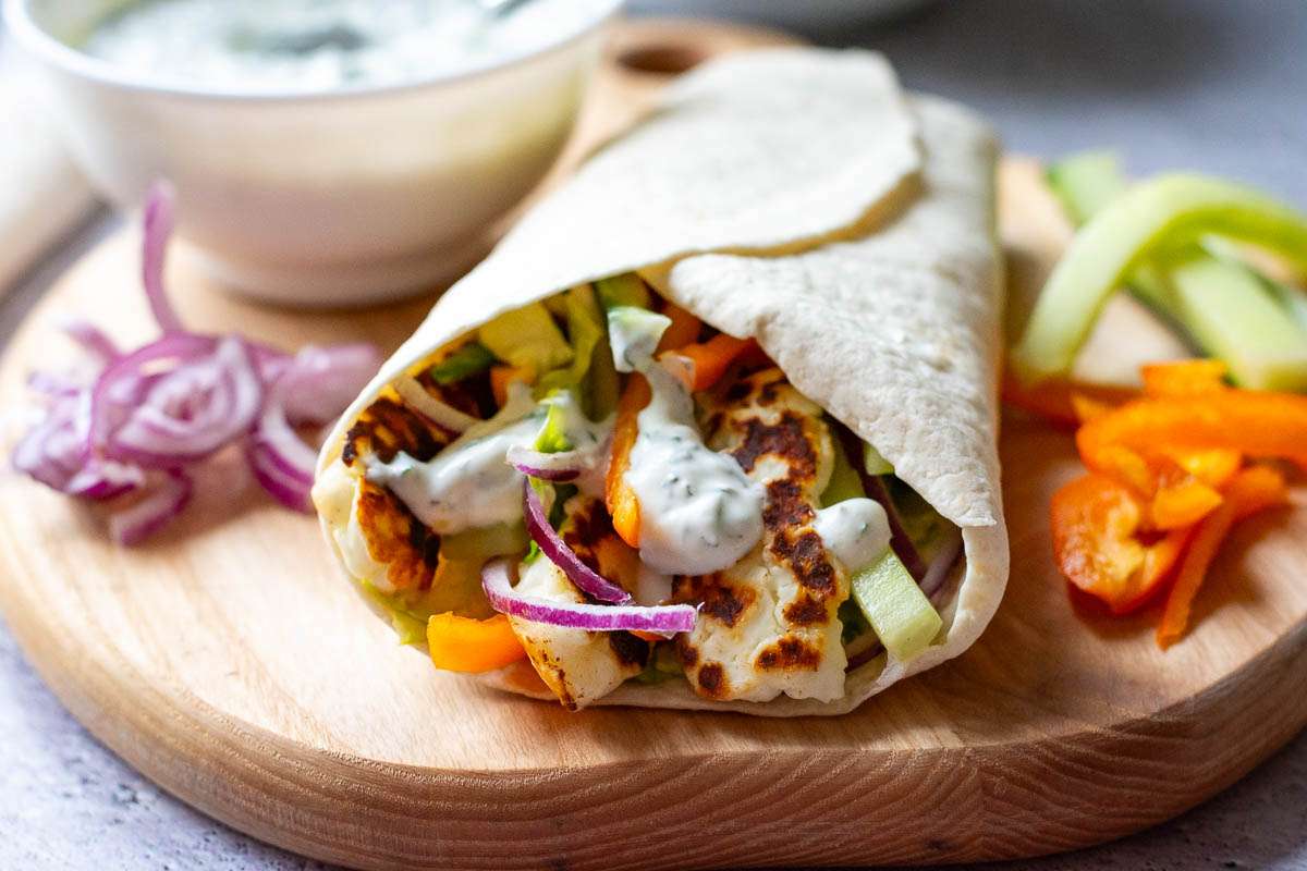 Halloumi, vegetables and greek yogurt sauce wrapped into a tortilla wrap.
