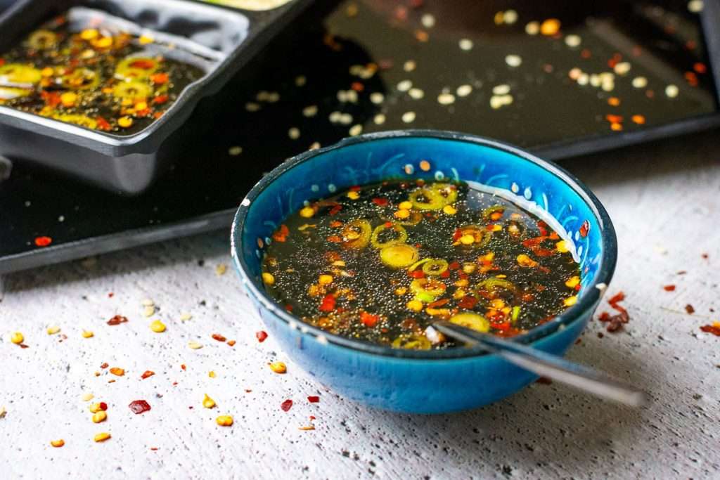 Prepared sauce for the potstickers in a small blue bowl.