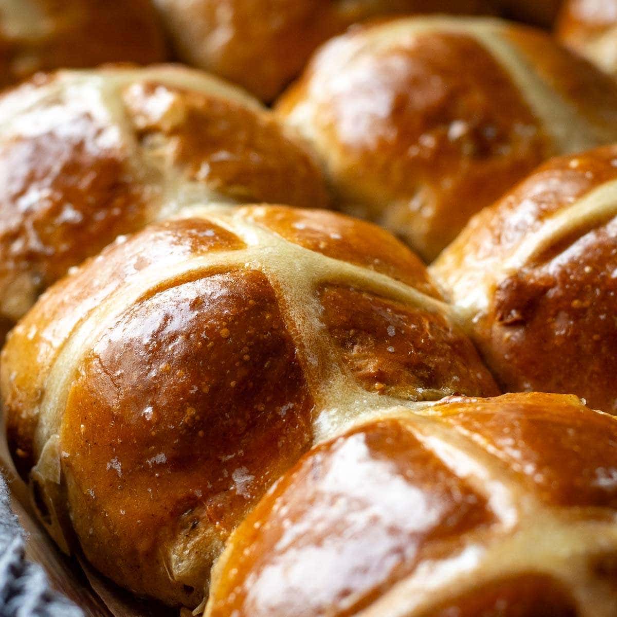 Baked Sourdough Discard Hot Cross Buns glazed with sugar syrup.