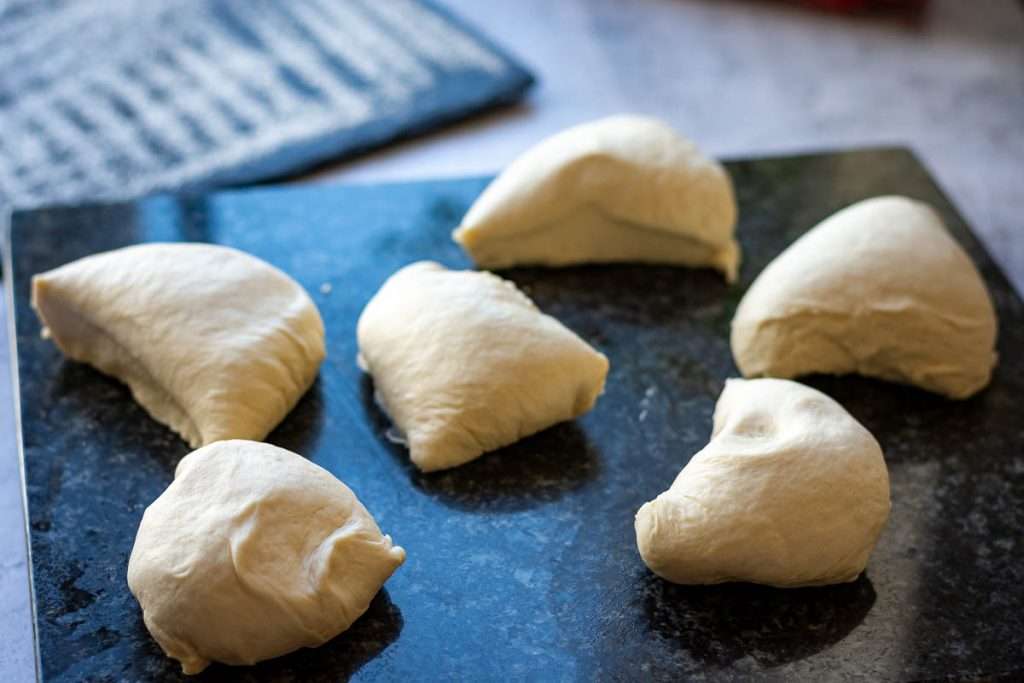 Naan dough divided into 6 even pieces.