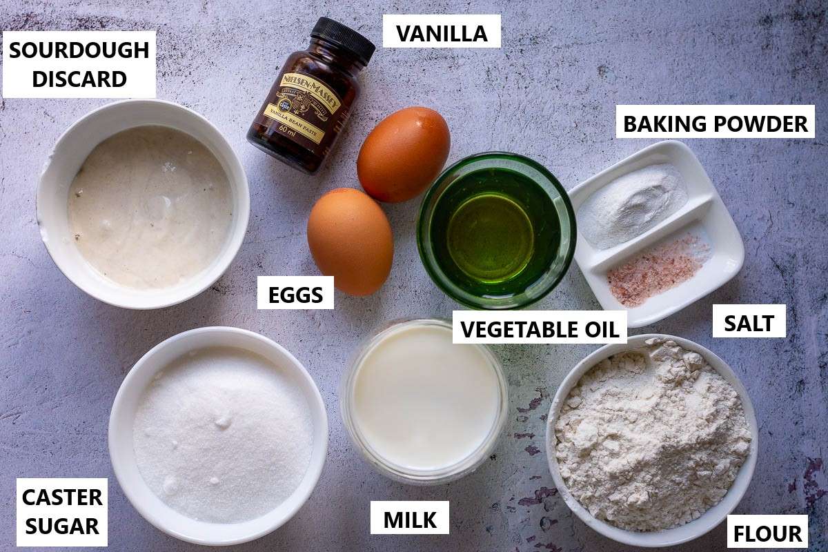 Ingredients for sourdough vanilla cupcakes in a light grey surface.