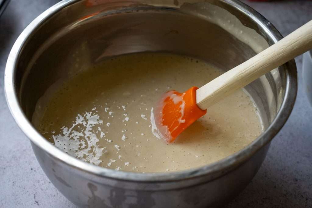 Sourdough vanilla cupcake batter in a metal bowl.