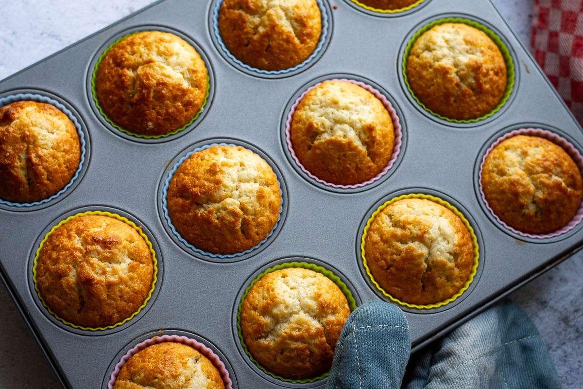 Sourdough cupcakes in a 12 - hole muffin tin.