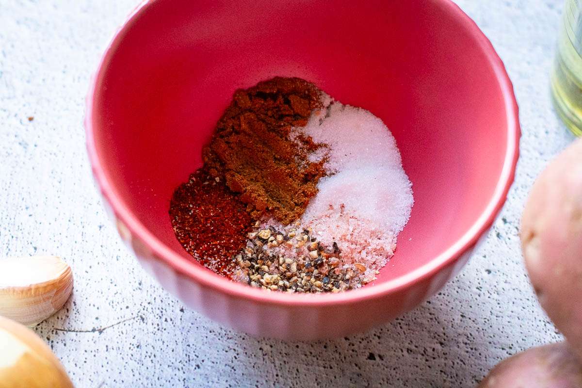Seasoning ingredients for Salt and Pepper chips in a small pink bowl.