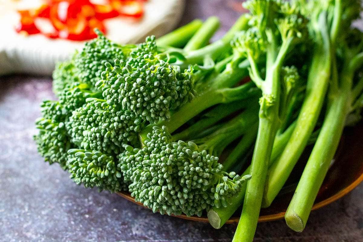 Tenderstem broccoli on a small brown plate.