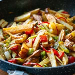 Chinese Takeaway style Salt and pepper chips in a large frying pan.