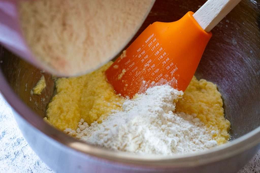 Adding flour to the wet ingredients.