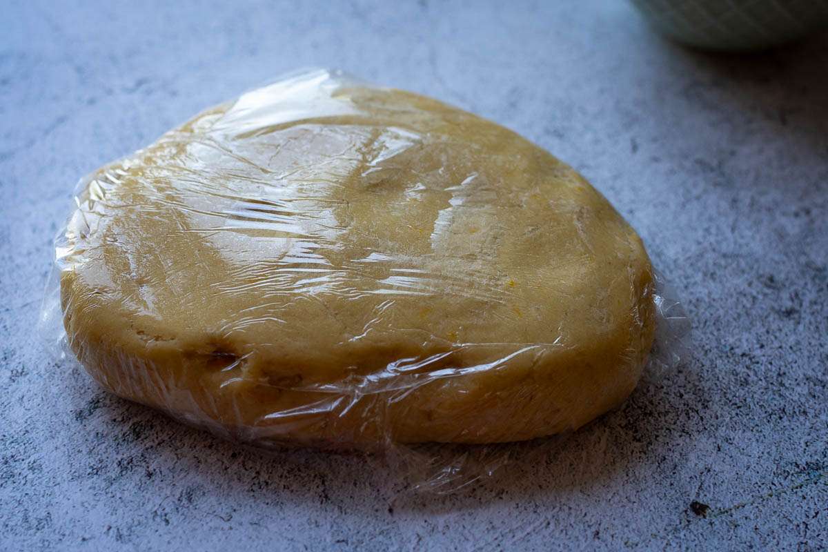 Lemon thumbprint cookie dough wrapped in plastic wrap.