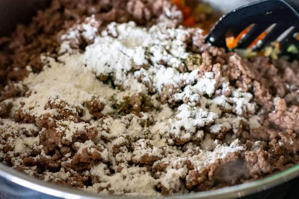Beef and flour added to the vegeatble pan.