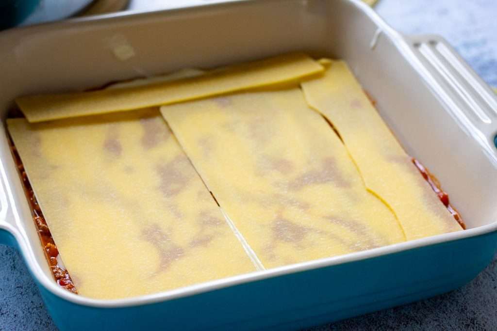 Lasagna cheets covering the beef and bechamel sauce.