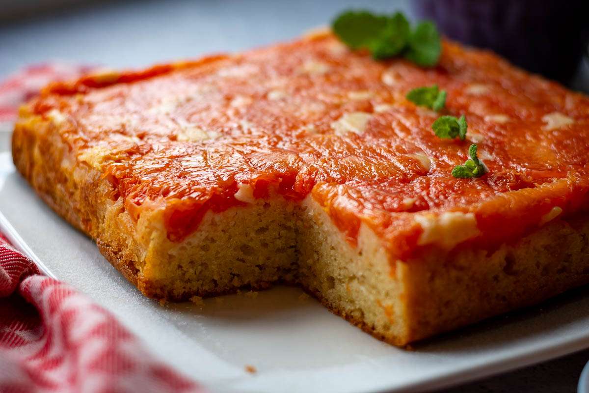 grapefruit cake with one slice missing.