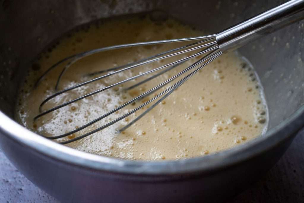 Dutch Baby batter ready in a metal bowl.