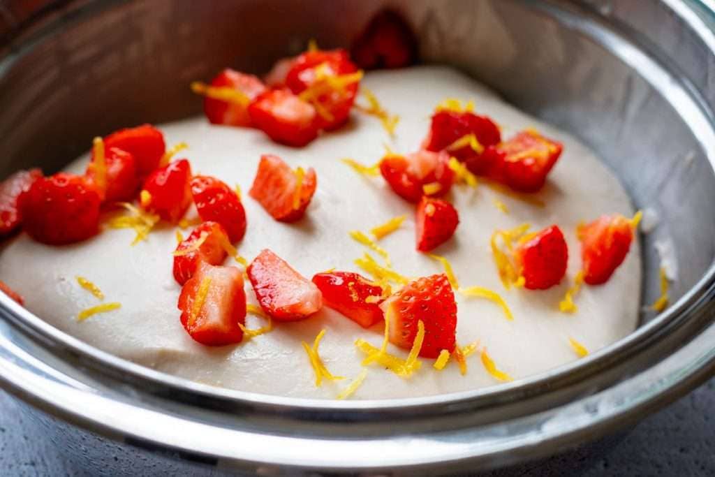 Strawberries and lemon scattered on top of the sourdough.