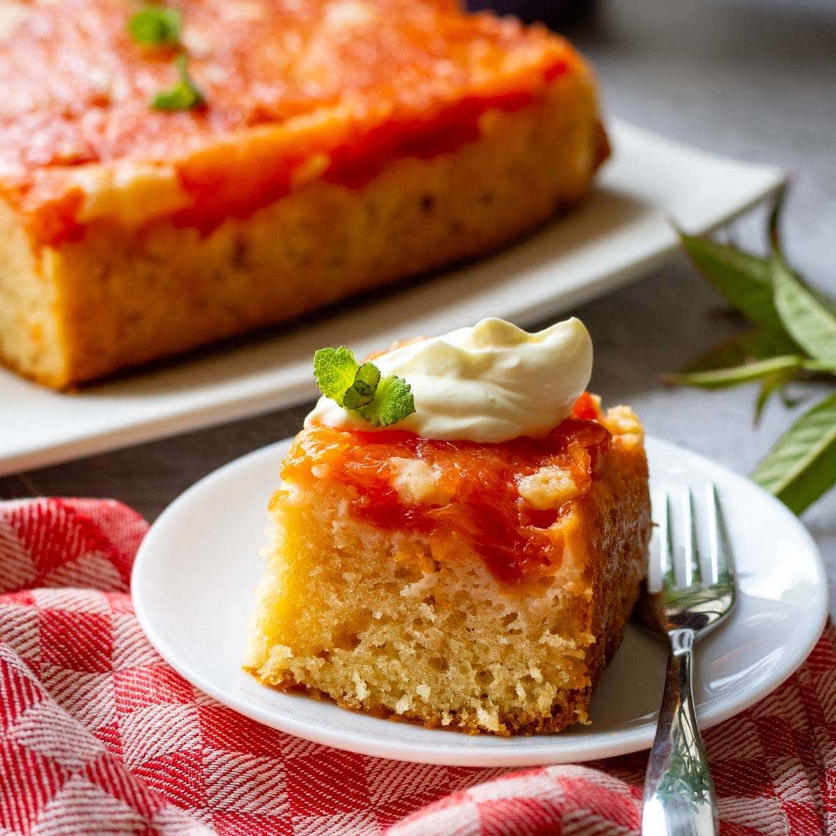 A slice of grapefruit olive oil cake on a white plate.