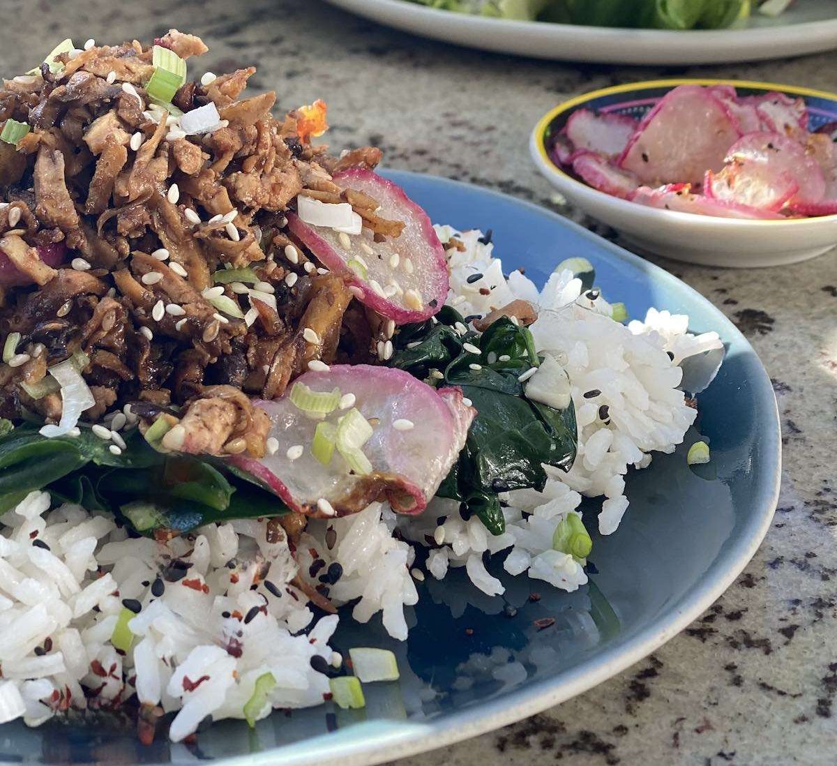 Shredded Bulgogi Tofu and Shiitake mushrooms on a blue plate with a side of radishes.