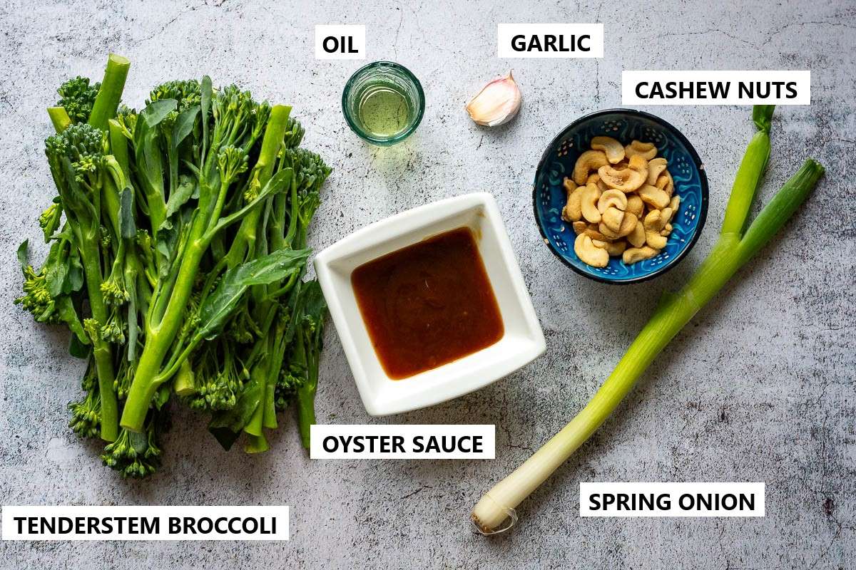 Ingredients for Tenderstem broccoli stir fry with oyster sauce on a concrete surface.