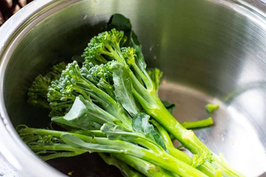 Tenderstem broccoli in a small pan.