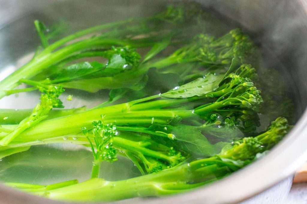 Tenderstem broccoli in boiling water.