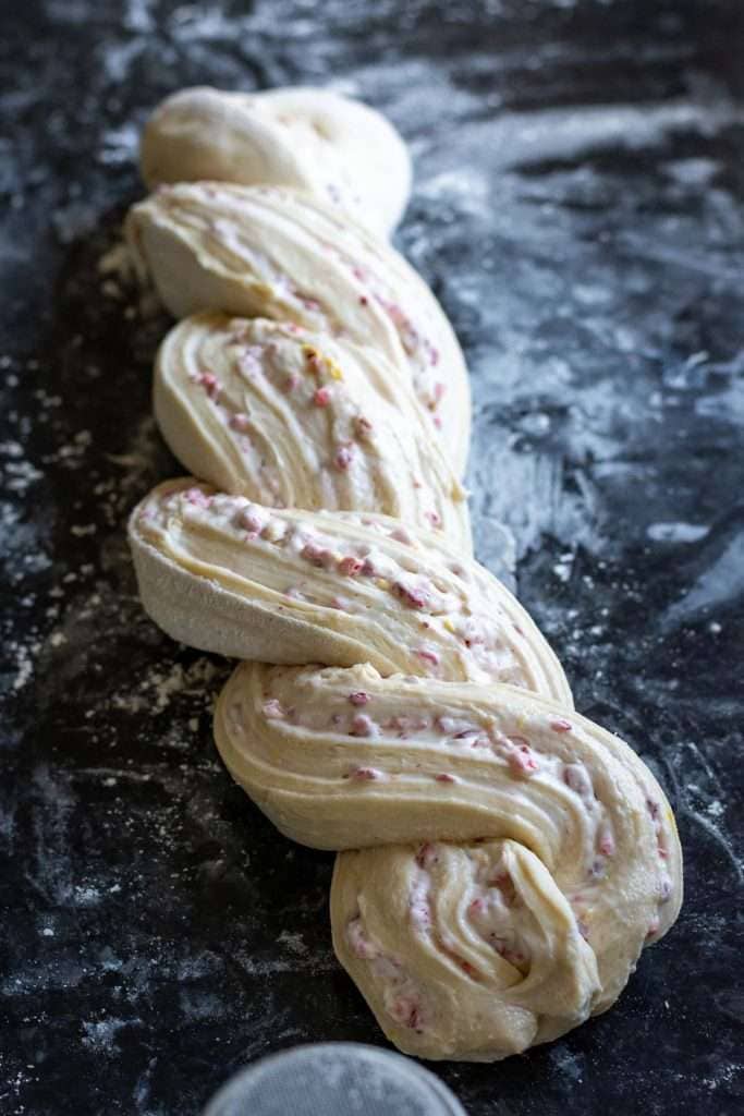 Twisted sourdough babka on a floured kitchen surface.
