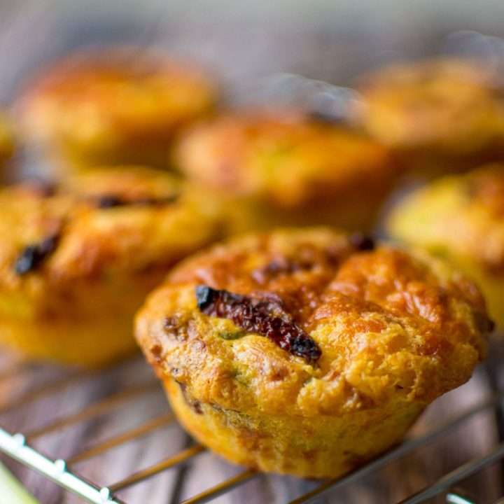 Savoury polenta muffins cooling on a wire rack.