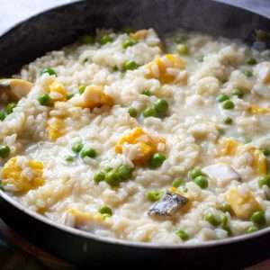 Smoked Haddock Risotto with peas in a large frying pan.