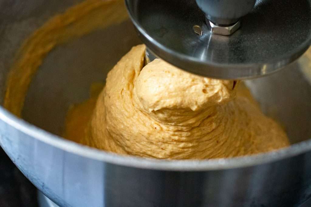 Orange sourdough in amixing bowl.
