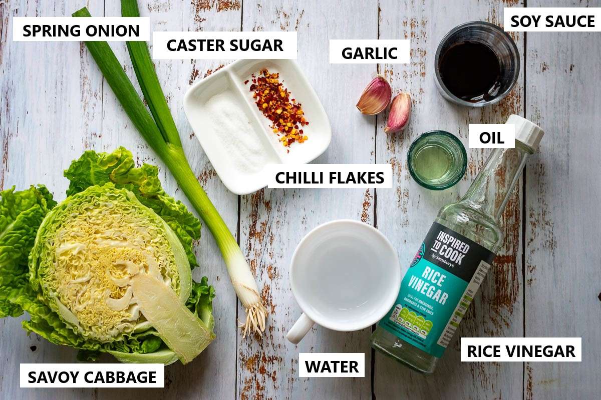 Ingredients for Savoy Cabbage Stir Fry ona white rustic wooden table.