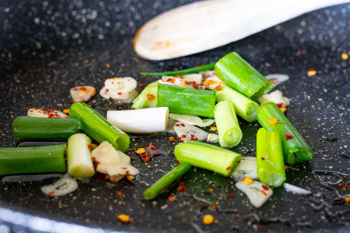 Garlic, Chilli and Spring onions in a frying pan.