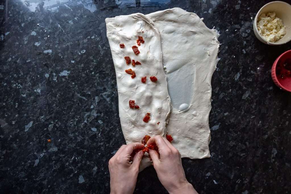 Feta and sundried tomatoes being laminated into the sourdough.