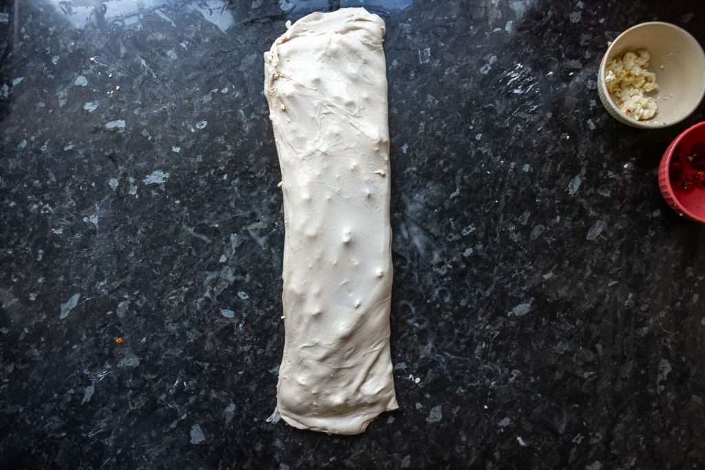 Feta and sundried tomatoes being laminated into the sourdough.