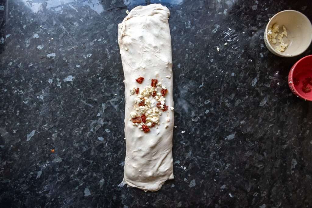 Feta and sundried tomatoes being laminated into the sourdough.