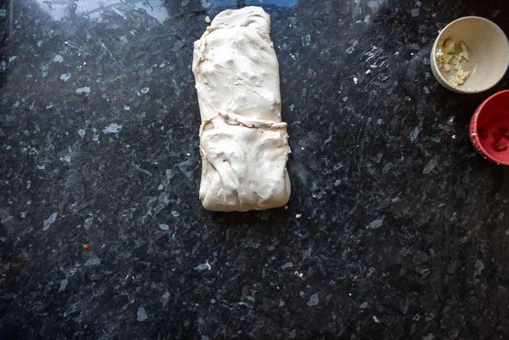 Feta and sundried tomatoes being laminated into the sourdough.