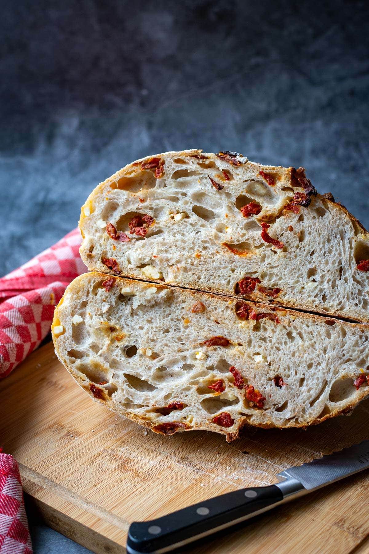 Sourdough with feta and sundried tomatoes cut in half.