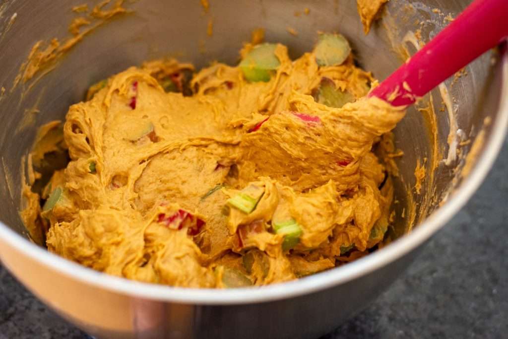 Rhubarb being mixed into the sourdough cake batter.