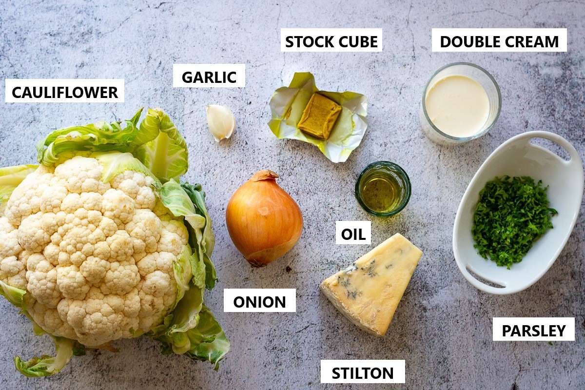 Ingredients for Cauliflower and Blue cheese soup on a light grey surface.