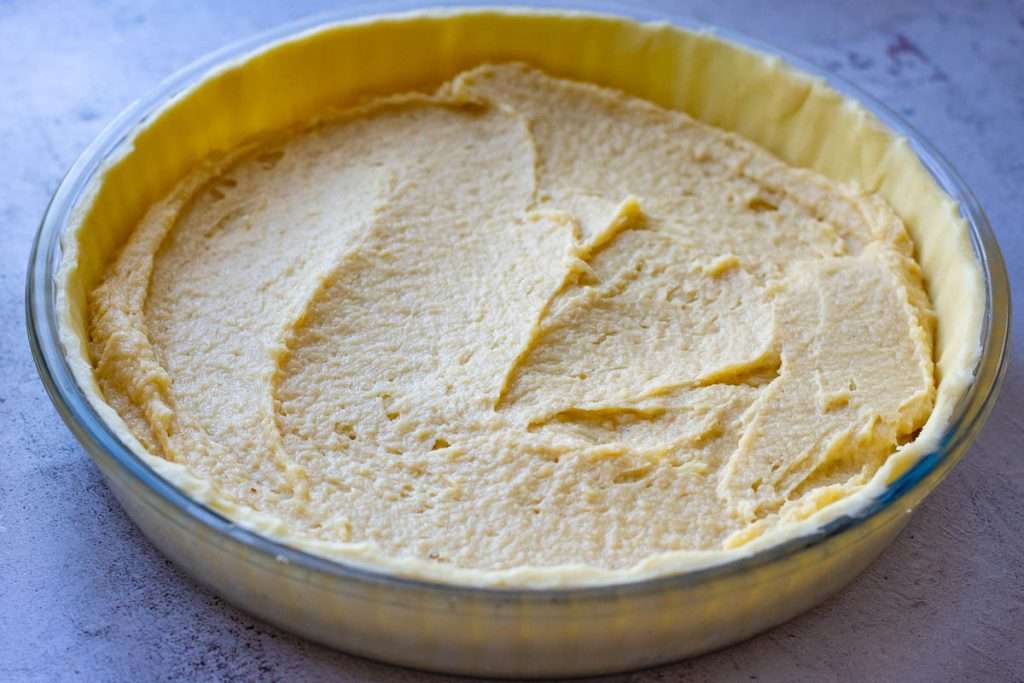 Frangipane mixture spread in the tart case.