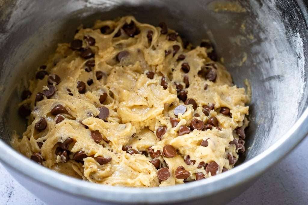 Sourdough chocolate chip cookie dough ready to chill in a metal bowl.