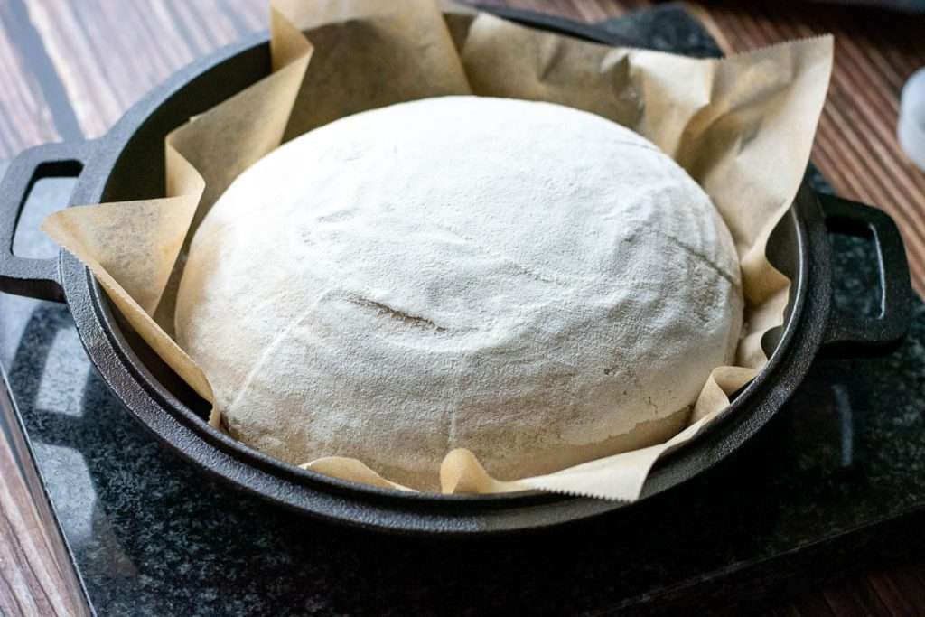 Sourdough placed on the lid of Dutch oven.